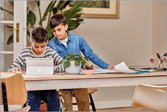 طالبان يافعان يلقيان نظرة على جهاز Microsoft Surface
