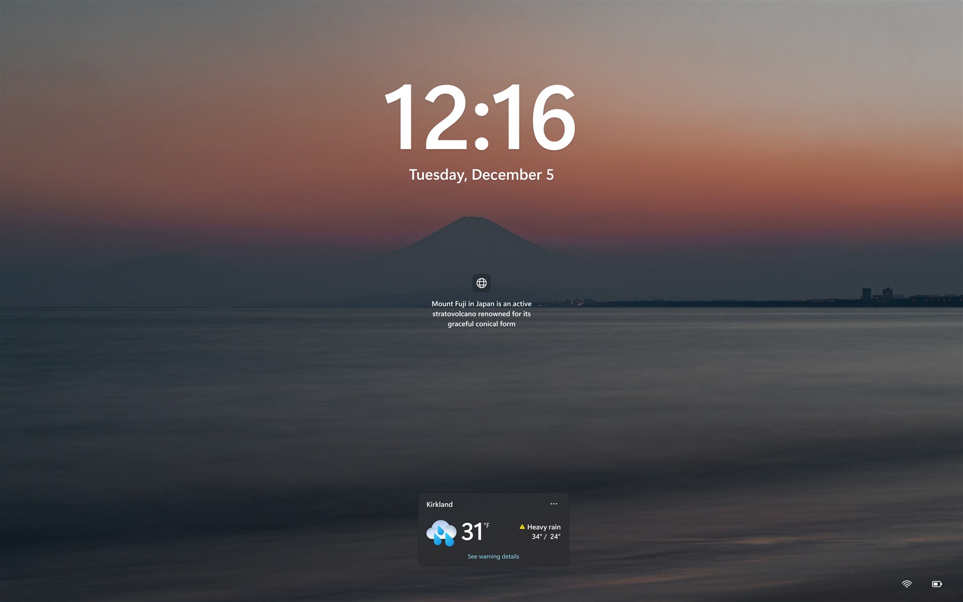 Windows 11 lock screen displaying a weather widget near the bottom of the screen.
