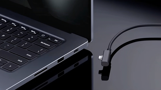 Photo of the Surface Magnetic Cable connecting to the USB-C with Magnetic Connect port on the right side of the laptop base.