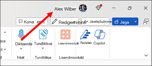 A picture with a red arrow pointing to the current primary user name which is on the app title bar towards the top right of the window.