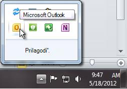 Notification area expanded to show the Outlook icon