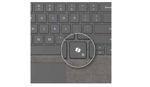 Ảnh chụp màn hình phím Copilot trên Bàn phím Surface Pro màu bạch kim có vùng lưu trữ bút dành cho Doanh nghiệp.